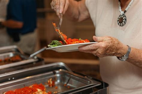 Premium Photo | Hand delicately savoring food representing the joy and ...