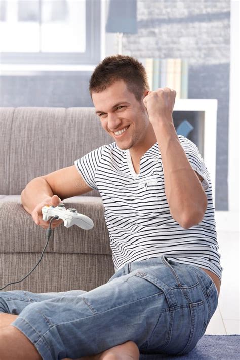 Young Man Enjoying Computer Game at Home Stock Image - Image of carpet ...