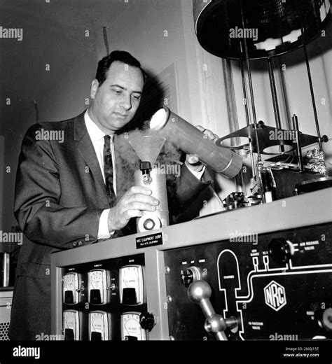 Scientist and inventor of the laser Dr. Theodore Maiman pours liquid nitrogen into a cooling ...