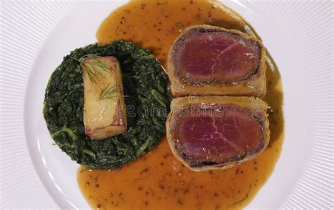 Beef Wellington with Spinach and Fried Potatoes.Close Up Stock Photo - Image of recipe ...