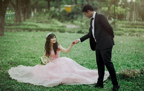 Free photo: Man in 2-piece Suit Holding Woman in Peach-colored Wedding Gown White Holding Her ...