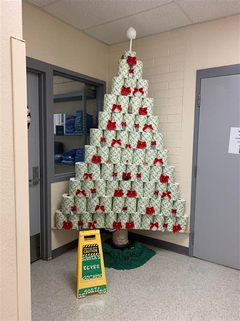 A Christmas tree made out of toilet paper rolls and scrub brushes. : r/ATBGE