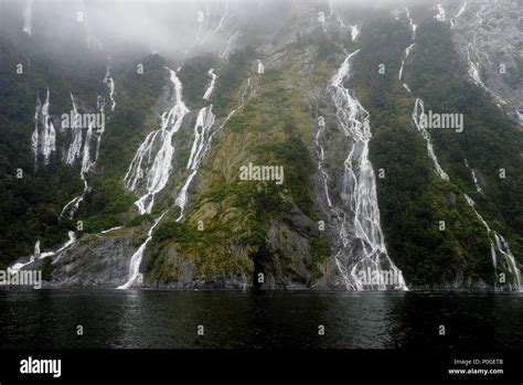 Hundreds of waterfalls flowing from the mountains during the rainstorm in Fiordland National ...