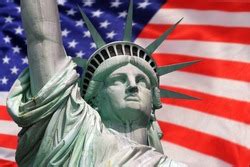 the statue of liberty with the blurry american flag waving in the background. Democracy and ...