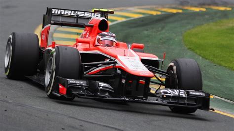 a man driving a race car on a track