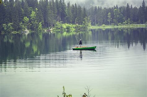 Royalty-Free photo: Person on Green Boat Fishing on Body of Water | PickPik