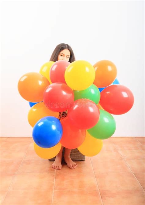 Girl Behind Inflating Balloons Stock Photo - Image of yellow, teen: 167954824
