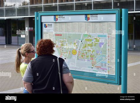 Visitors at campus site map of Maynooth University in town of Maynooth ...