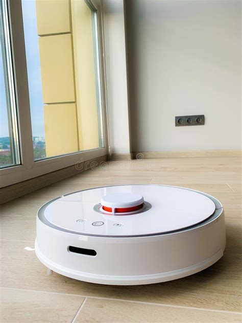 White Robot Cleaner. Robot Vacuum Cleaner on Laminate Floor in Action Stock Photo - Image of ...