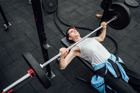 Dumbbell vs. barbell bench press: Who's the pectoral champ?