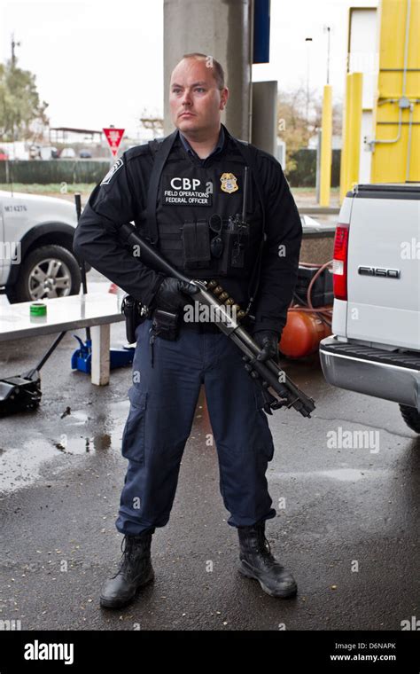 A US Customs and Border Protection officer watches the San Luis Stock ...