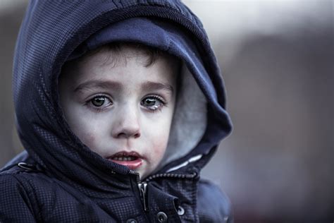 sad little boy with coat - Wyoming Department of Health