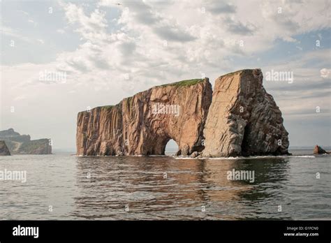 Rocher Percé is a massive rock formation emerging out of the Gulf of St ...