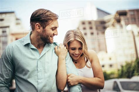 Happy tourist couple walking on street together. Young woman walking ...