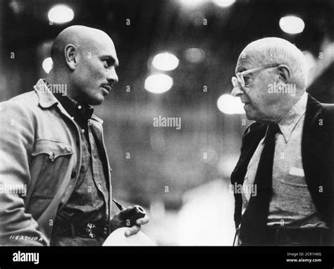 YUL BRYNNER and CECIL B. DeMILLE on set candid during filming of THE ...