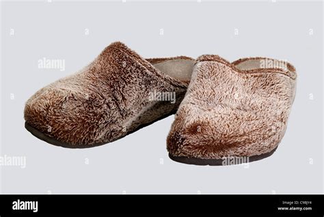 a pair of brown fluffy slippers in light grey back Stock Photo - Alamy