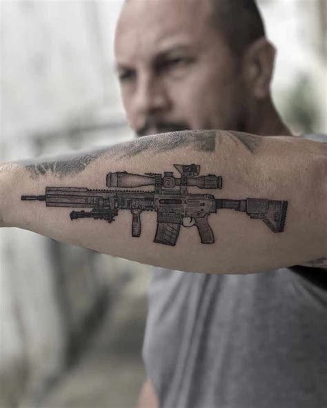 Details 70+ gun tattoo on arm super hot - in.coedo.com.vn