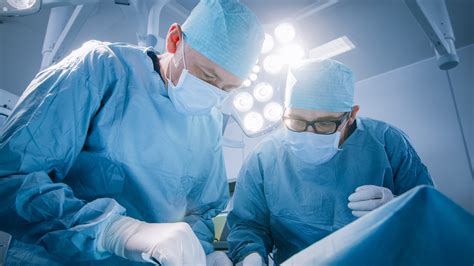 Low Angle Shot In Operating Room of Two Surgeons During the Surgery ...