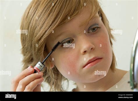 young boy putting makeup on pretending to be a girl Stock Photo - Alamy