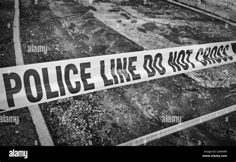 Police crime scene tape warning Black and White Stock Photos & Images - Alamy