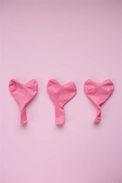 Pink balloons in form of heart against pink background · Free Stock Photo