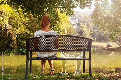 Depressed and sad young woman sitting alone on bench in the park. Stock Photo | Adobe Stock