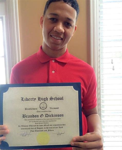 a young man is holding up a certificate