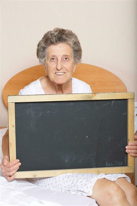 Old woman between 70 and 80 years old with a black chalkboard 26303902 ...