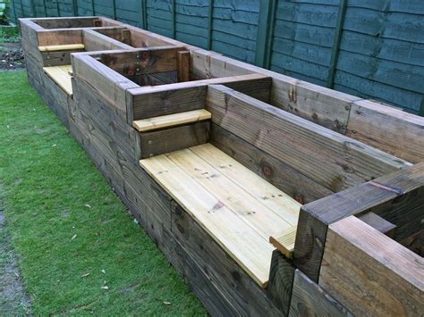 Les Mable's raised beds with bench seats from new railway sleepers. Railwaysleepers.com