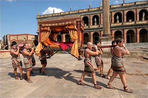 Patrician in his litter carried by slaves in the Roman Forum in front of what appears to be the ...