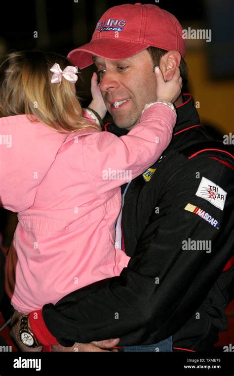 Stacy Compton plays with his daughter just prior to the start of the NASCAR Craftsman Chevy ...