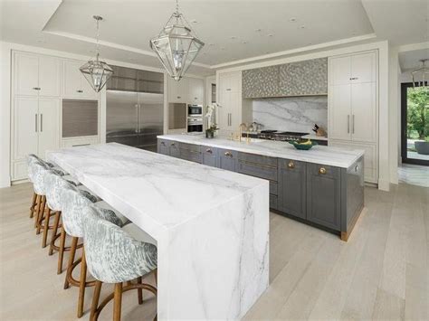 Calcutta Marble Waterfall Kitchen Island with Blond Wood Floors | Kitchen island with seating ...