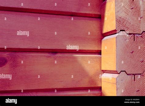 The building is made of square wooden beams. The outer wall, joint. Toned photo Stock Photo - Alamy