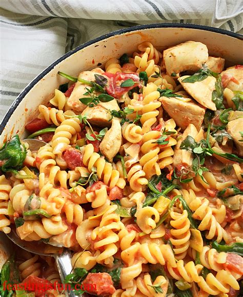 Creamy Tomato Spinach Chicken Pasta - Feasting Is Fun