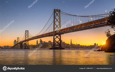 San Francisco skyline with Oakland Bay Bridge at sunset, California ...