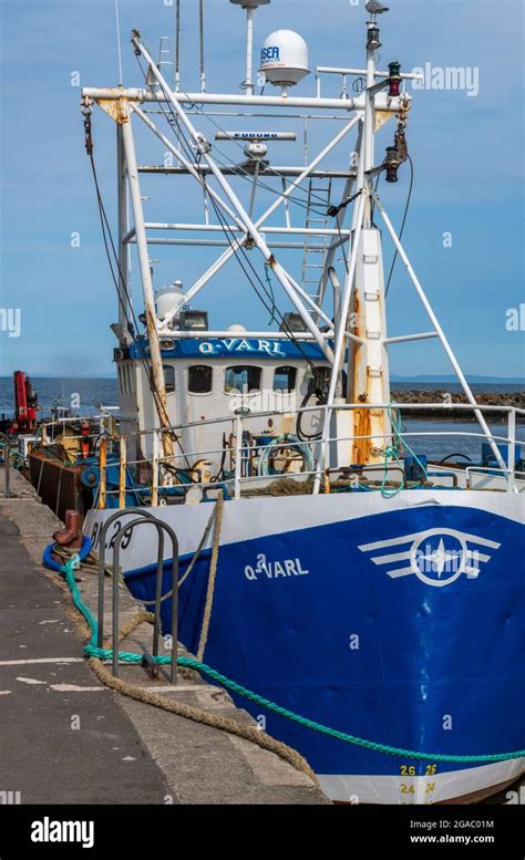 Fishing trawlers and boats alongside the wall berthed in Girvan harbour, Ayrshire, West coast of ...