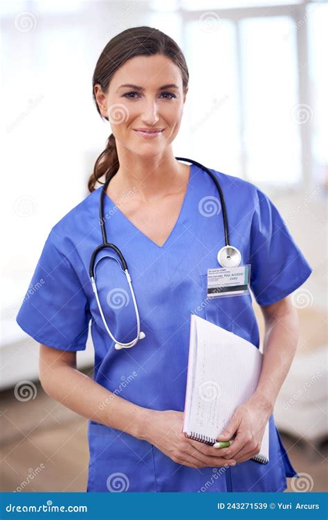 Happy To Heal. Portrait of a Young Female Doctor in Scrubs. Stock Image ...