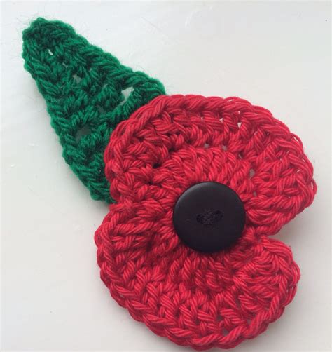 Hand crocheted poppy brooch with leaf. Donation to British Legion with ...