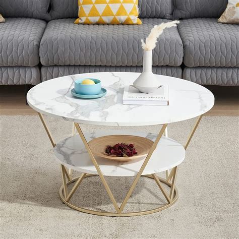 a white marble coffee table in front of a gray couch