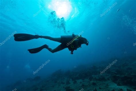 Female scuba diver silhouette underwater Stock Photo by ©jag_cz 100414644