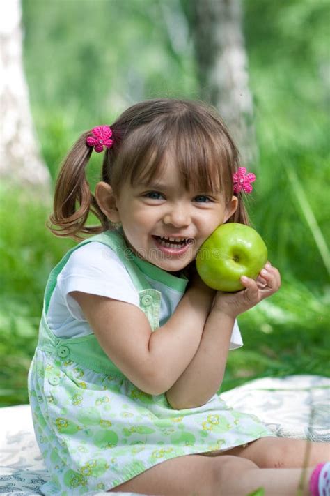 Little Girl with Green Apple Outdoor Summertime Stock Photo - Image of ...