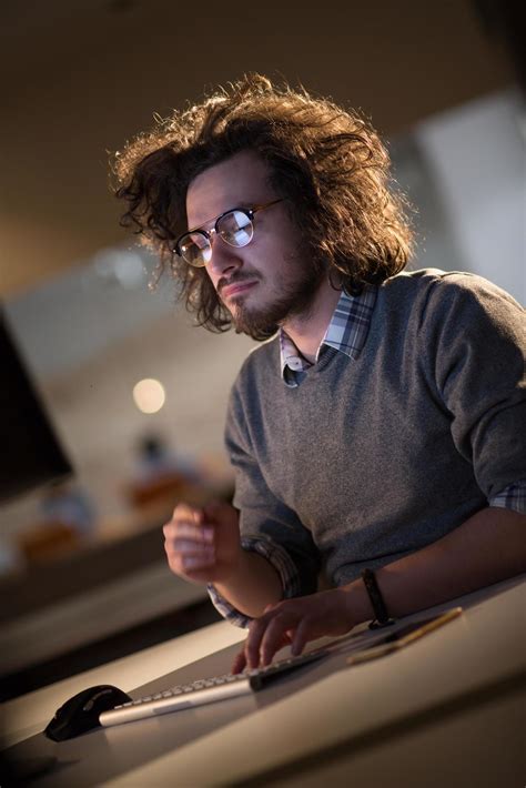 man working on computer in dark office 12438906 Stock Photo at Vecteezy