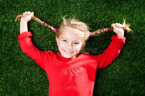 Little Girl Smiling on Grass Stock Image - Image of blond, outside: 21891547