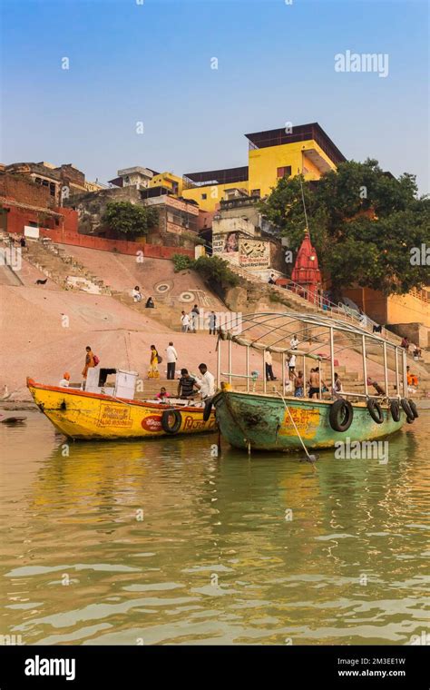 Colorful boats at the Ganges river in Varanasi, india Stock Photo - Alamy