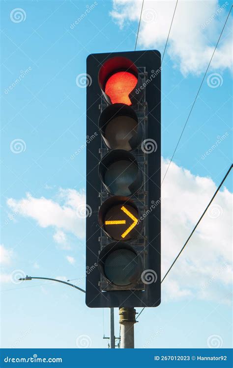 Red Color and Yellow Arrow on the Traffic Light with Cloudy Sky on the ...