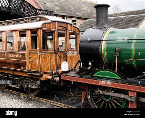 Green steam locomotive and carriage Stock Photo - Alamy