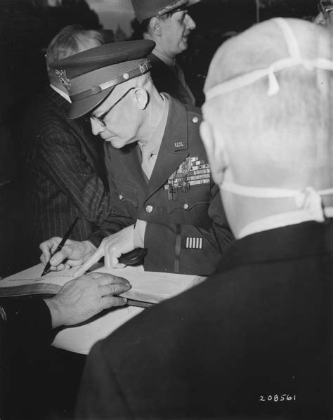 General Dwight D. Eisenhower signs the register at the tomb of the ...