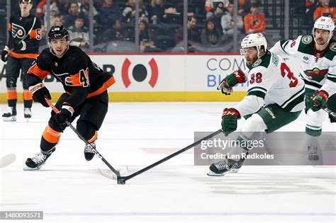 Ryan Hartman of the Minnesota Wild reaches for the loose puck against ...