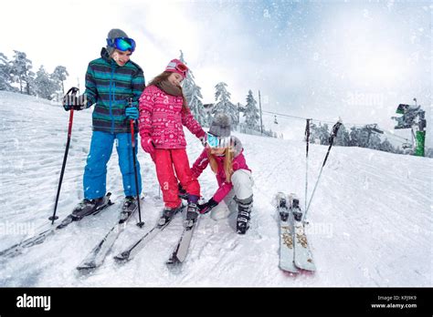 Skiing, winter fun-Mother preparing for skiing happy kids Stock Photo - Alamy