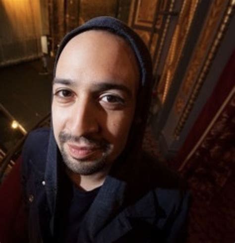 a man with a turban on standing in front of stairs